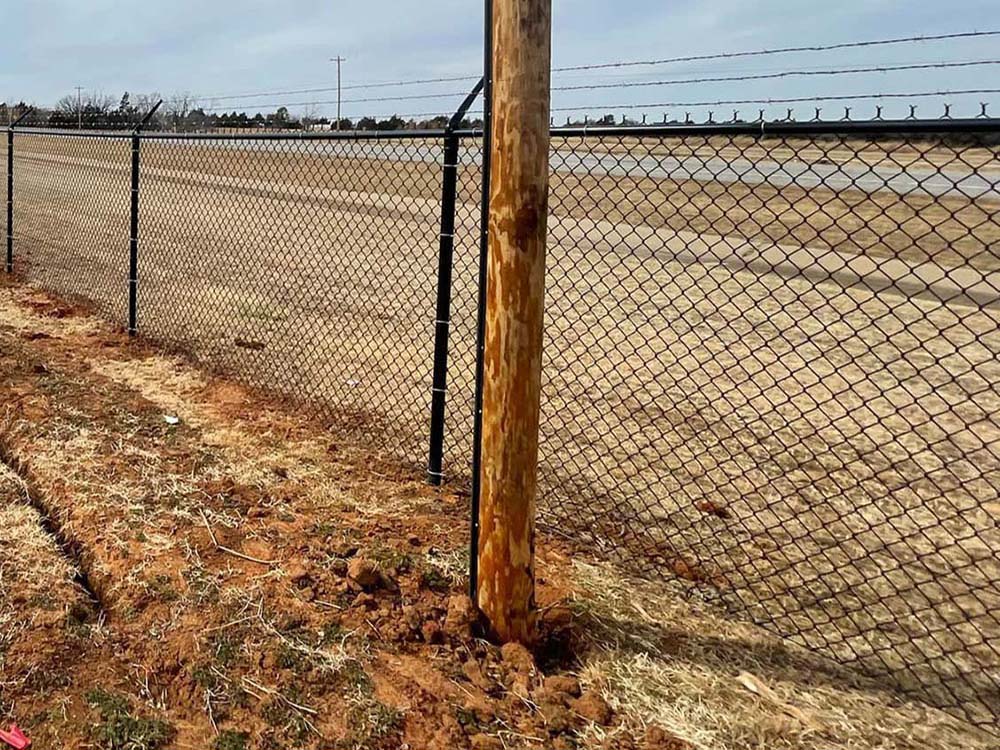 Chain link fence with barbed wire fence company in Oklahoma City